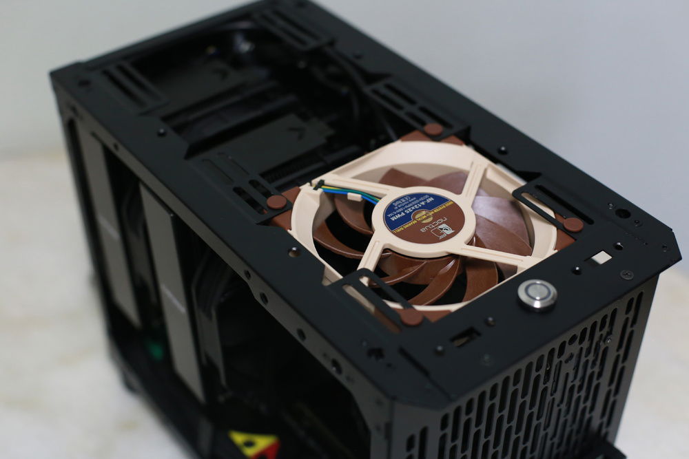 With the flipped length-wise PSU mounted like I have, you can adjust the height of the PSU and fit a 25mm fan at the top!