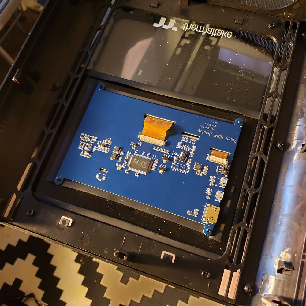 I added an acrylic frame with some rubber so it stays in place without having to be screwed on for easy removal.