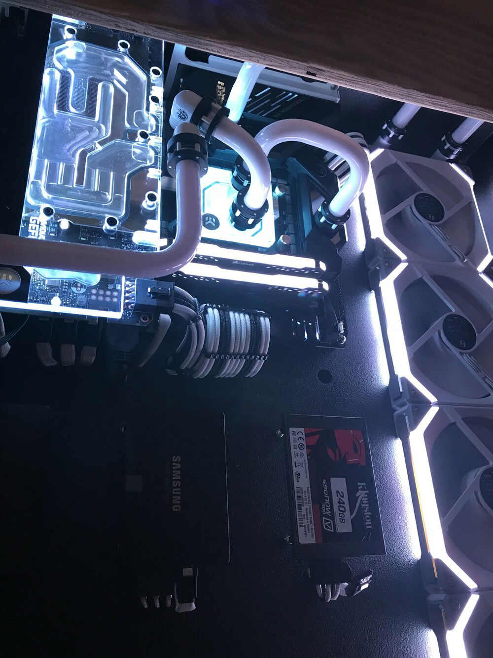 Leak testing done, final connections done and now its fired up! Still waiting on my custom cut glass top to come in. A piece of scrap plywood will have to work to hold my monitors, mouse and keyboard until it comes in. Still playing with lighting combinations with the RGB but I could not be happier with the way its turned out.