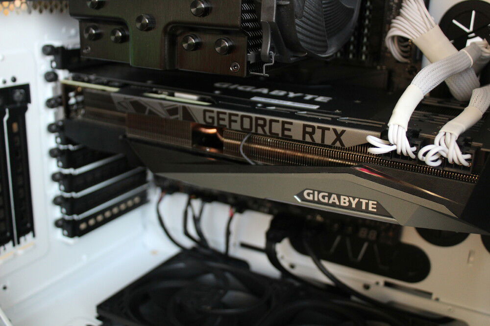 There is maybe 2 mm clearance between the gpu and the front fans, snug like a bug.