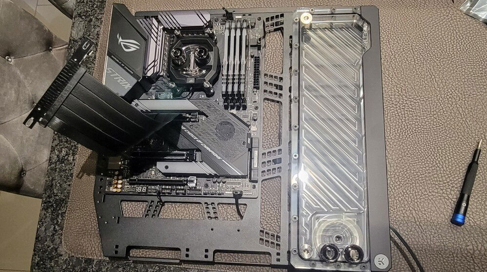 Mounted the pump/res combo to the motherboard tray. I've used twist ties to temporarily hold the cables until I can figure out where everything needs to go.