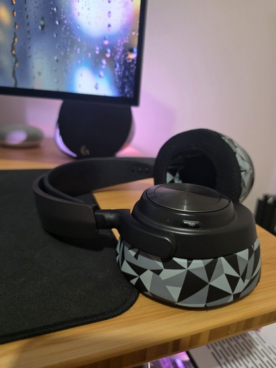 Steelseries Nova Pro X Wireless. Big sound, but strong noise cancelling to cut out the subtle hum of all those case fans. The hot swappable batteries (yeah, you get two) are the best feature I've seen in a headset - once I hear that low battery beep I can take the heaphones off, remove the flat battery, take the fresh one out of the base station, and slot it in. There is an 8 second buffer without the battery, so I don't even have to turn the headphones back on. I haven't had to plug them into anything unless there's a firmware update, and the Bluetooth lets me pair with the turntable in another room for when I want to hear some vinyl.

Had to change the earpads due to age - I've had these for years and they're too good to replace.