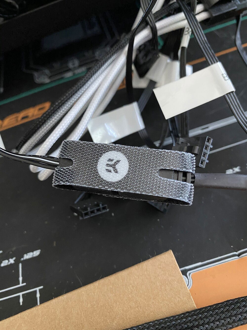 I love these little loops from EK. They help keep RGB cables plugged in. They're affixed via velcro. Such a simple solution.