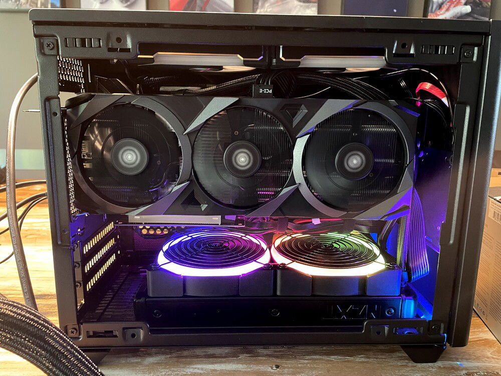 Cooling is actually pretty good with intake from the bottom fans and exhaust on the top provided by a pair SL120s