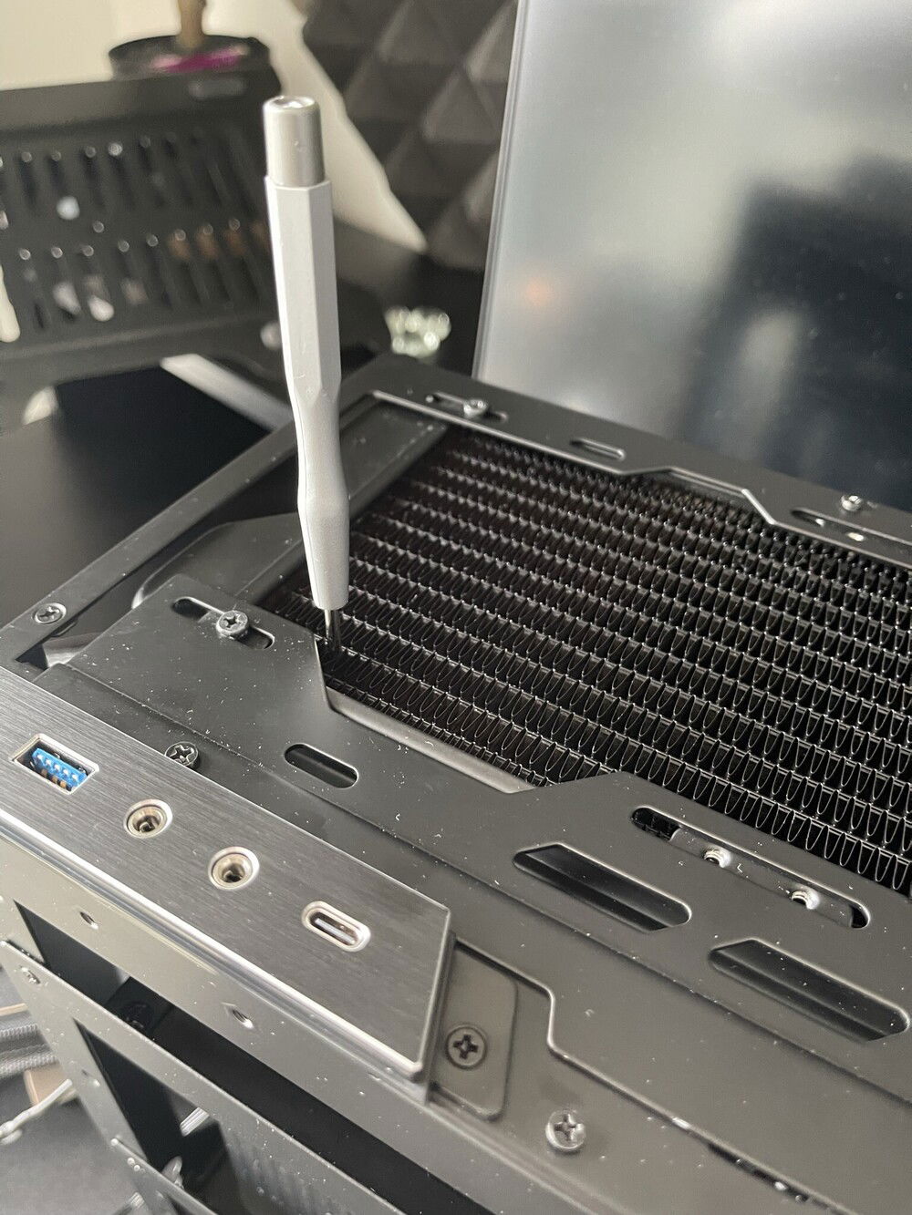 I had to thighten the PSU screws throught the radiator fins!