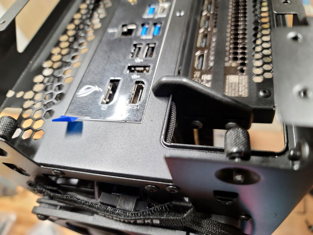 Upper GPU support bracket: hangs over the cutout lip and is bolted to what remains of the original GPU mounting bracket.