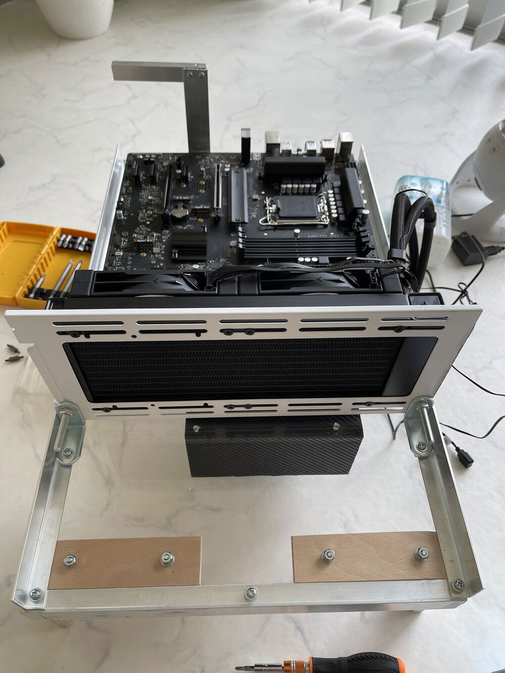 Used some brackets and an extra fan mount from a different case to install the AIO. The fans pull fresh air through the rad and blow it towards the rest of the board to cool everything else.