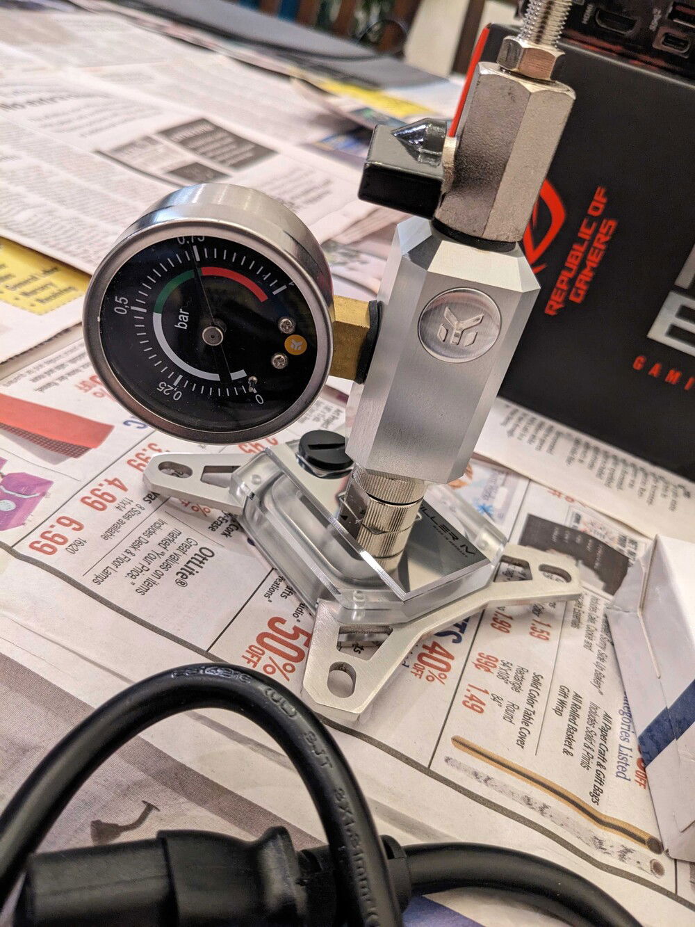 Leak testing the CPU block.  I prefer Aquacomputer to EK, but my Dr Drop pump was non-functional, so I grabbed EK's tester instead and it was much more reliable.