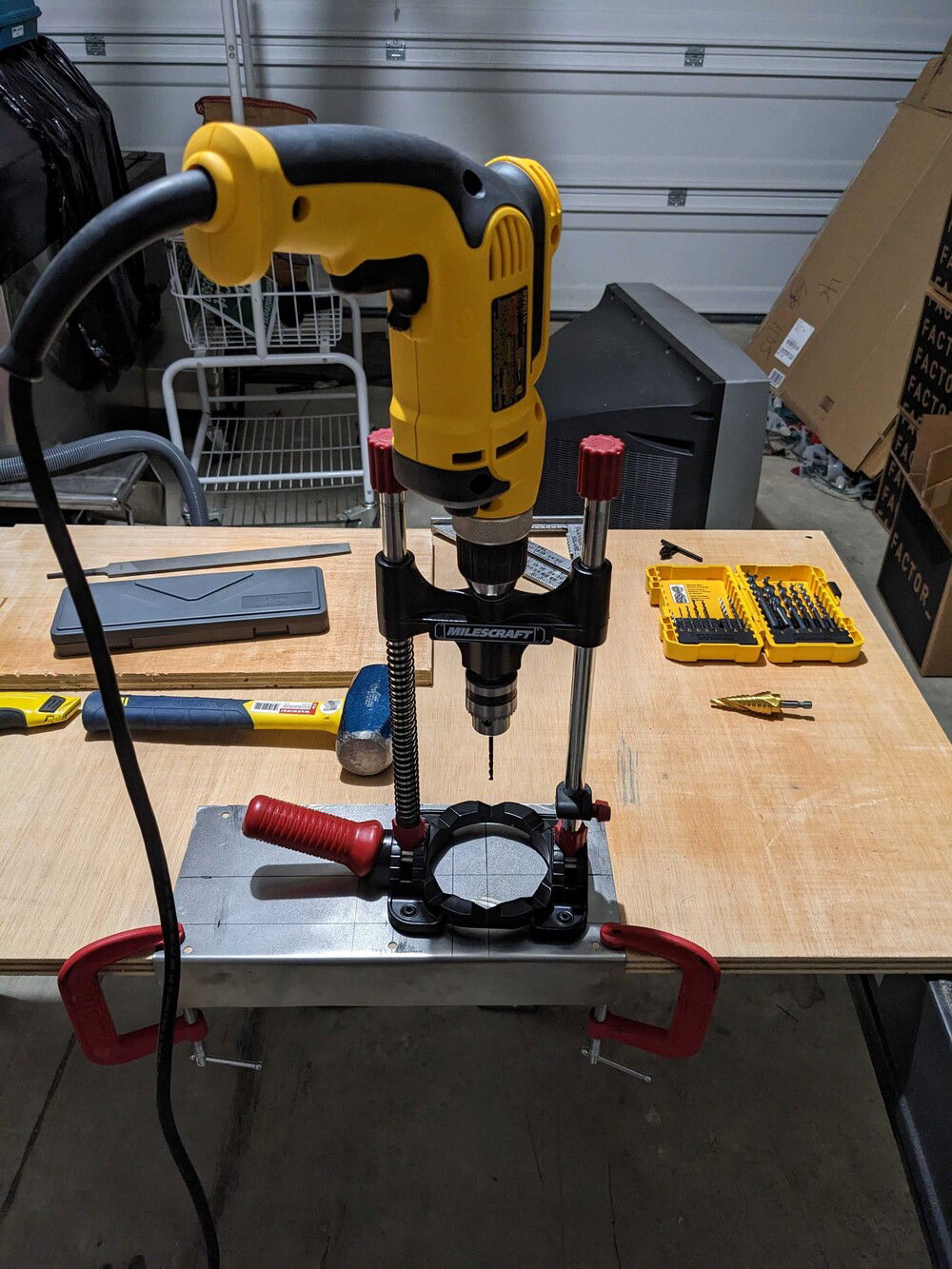 Temporarily installed the mobo/CPU and marked the plate for pass-through fittings using a laser level.  This drill jig isn't as solid as a drill press, but it did good work.  Made pilot holes with a small bit then went for the full hole with the stepper-bit.