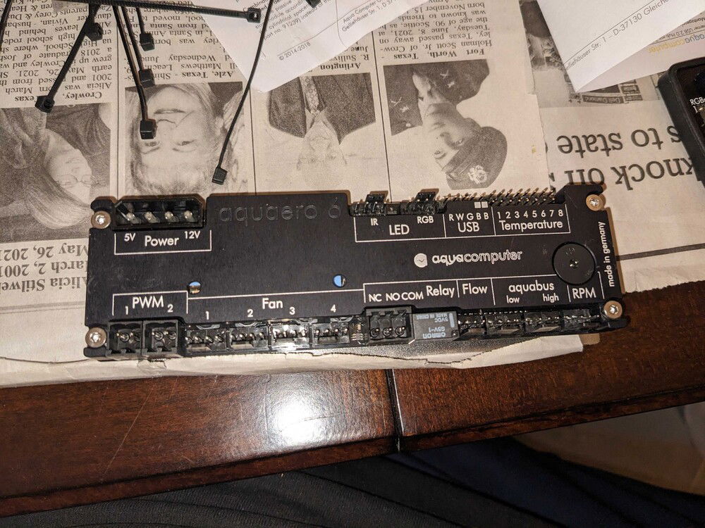 Aquaero 6 LT with heatsink.  I velcro-mounted all my Aquacomputer gear, but this goober is only set up for stand-offs and is intended to be mounted with screws to holes you drill in the case.