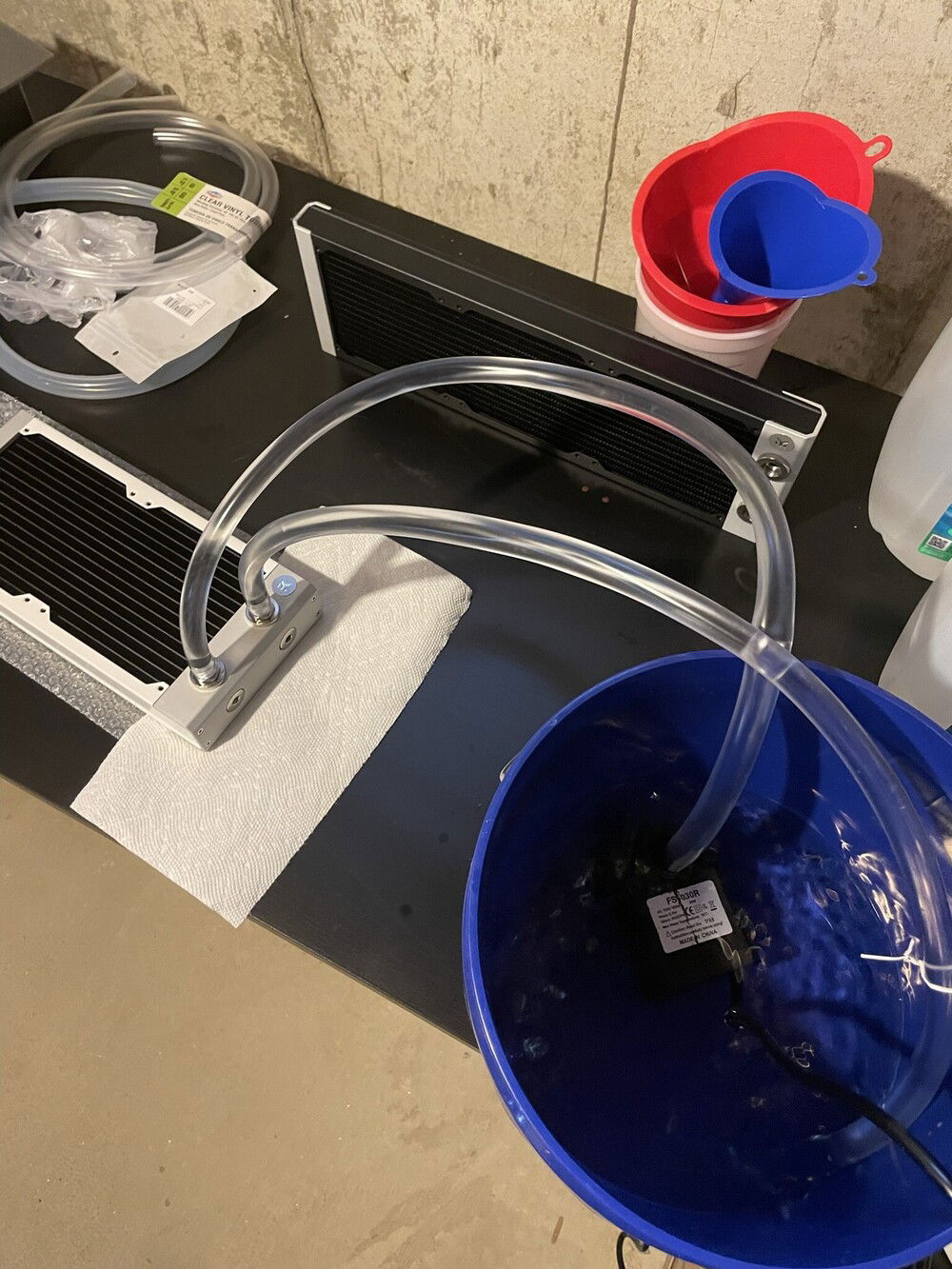 Went oldschool with some hardware store tubing and a fountain pump to flush the radiators. Used EK Loop Cleaner as directed - filled the radiators, capped them, shook them around, etc. Then ran EK Superflush in a loop for 24 hrs for each radiator.