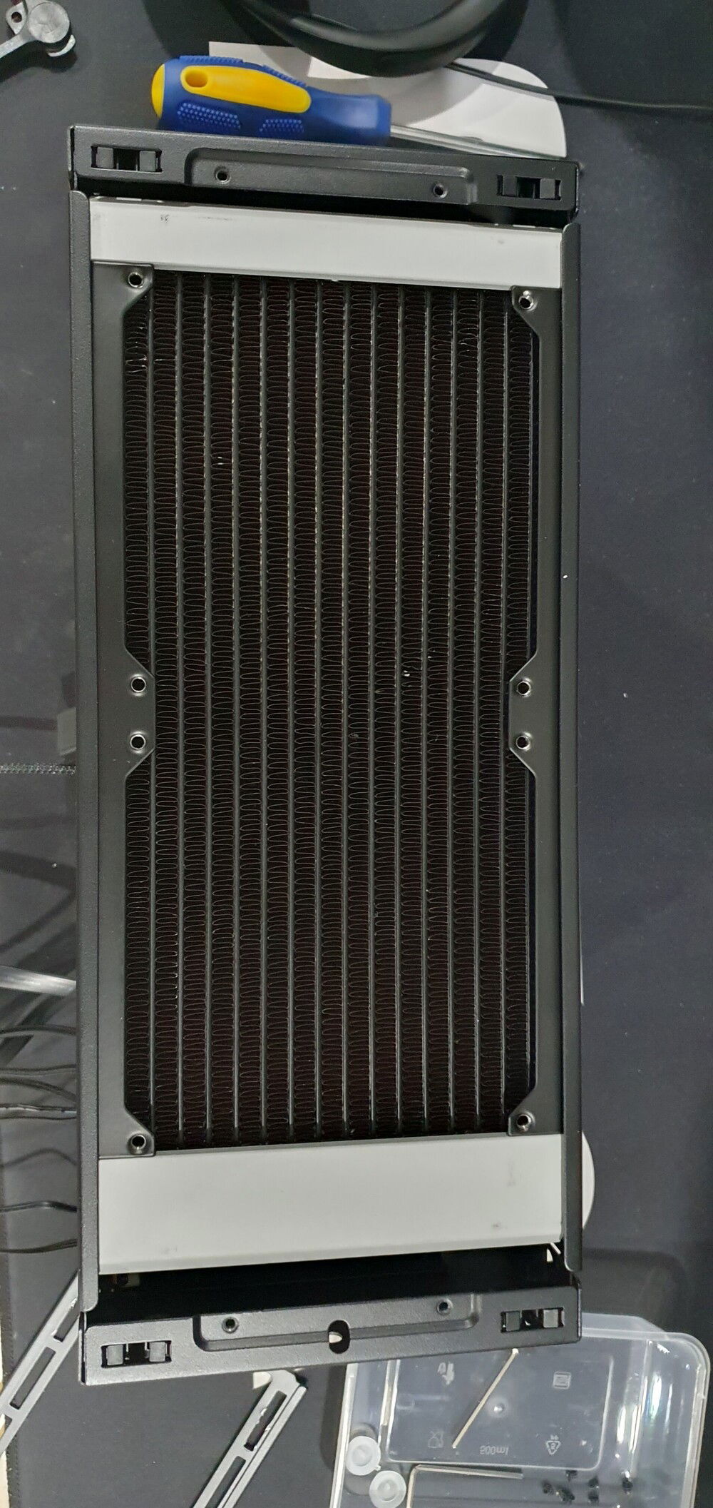 Push the radiator as far back as you can (up against the plug at the back). This will give you room to get the fittings in and also you can hide some cables in the space at the front.