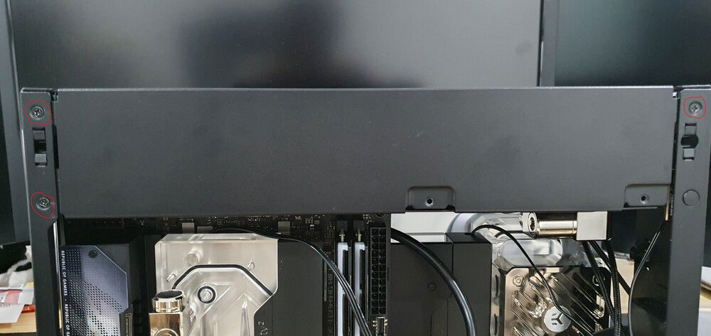 Getting in this radiator was a tight fit. Take off the circled screws on the side and front panels and kind of pop out the side panels on the top. This will give you enough room to sneak it in and then you can pop back in the side panels.