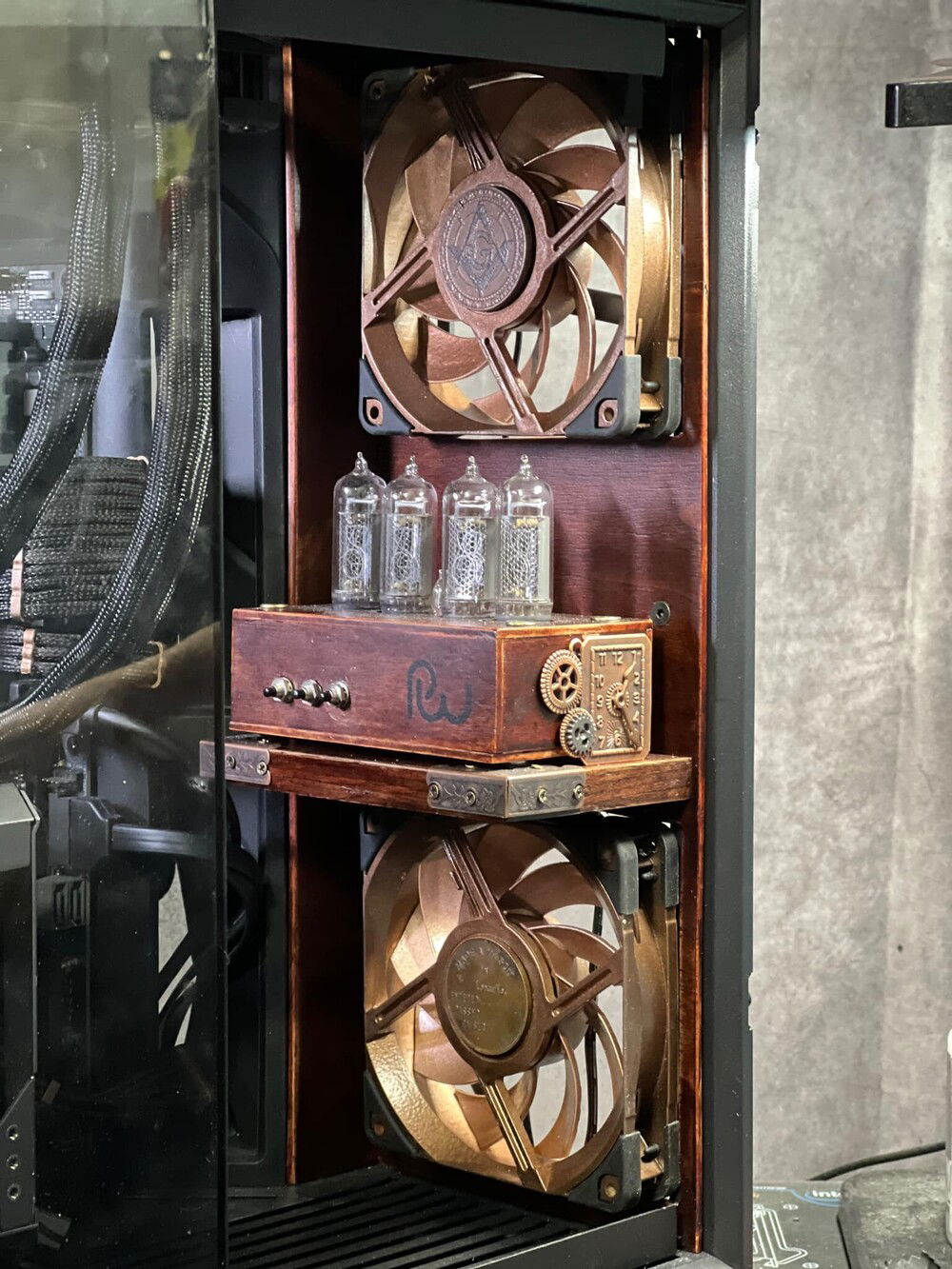 Nixie tube clock. I rebuilt the housing to fit in the build (both physically and aesthetically), but the internals of the clock are from Poltava Workshop in Ukraine - full credit to them for its functionality.