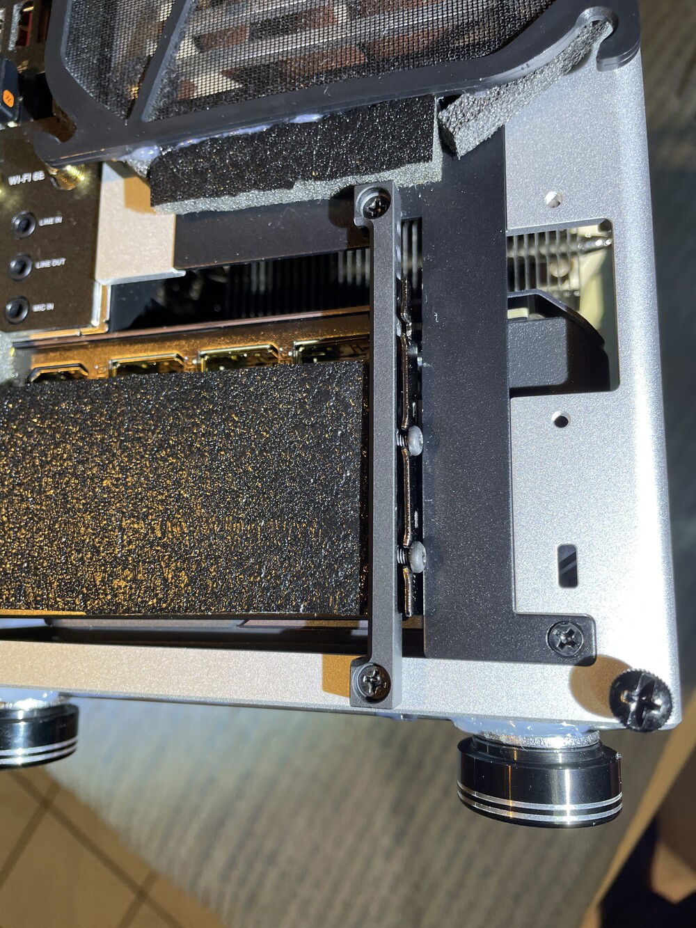 flimsy graphics card holder, should be made of steel, any angled screw will damage the thread here