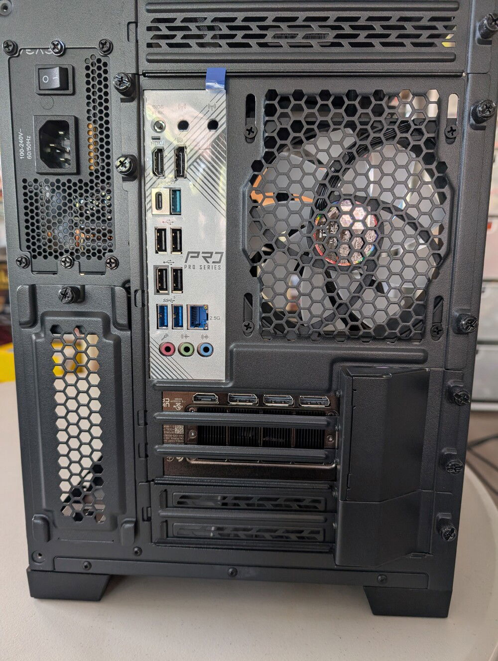 Rear fan, motherboard and GPU ports. PSU to the upper left of this view.