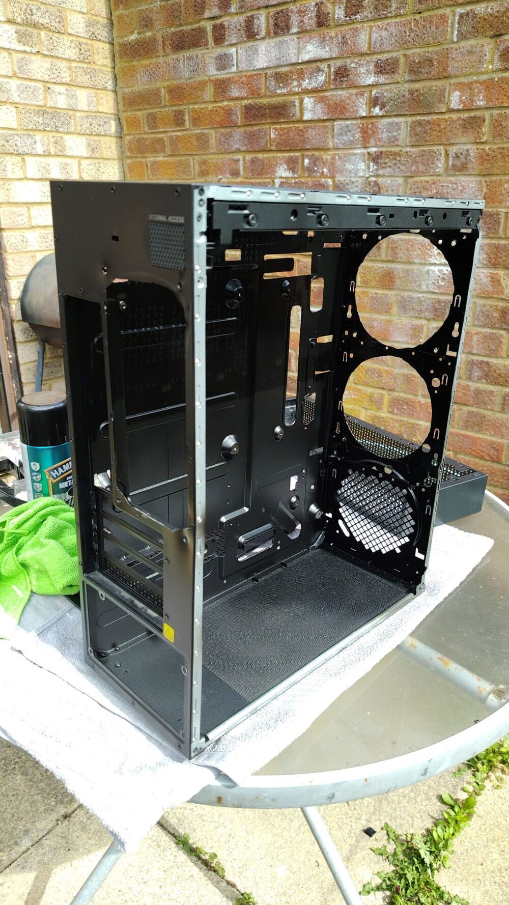 Neat enough cuts for two more front intake fans. The rear cut to fit two exhaust fans. What remained before of the HDD cage has been removed. Case thoroughly cleaned with isopropyl alcohol, vacuumed and sprayed black. Some modification to the top to route the cooling tubes for the AIO.