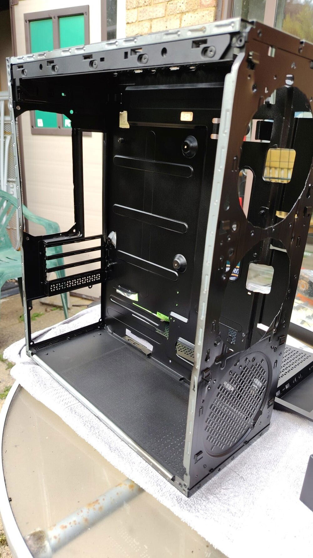 Neat enough cuts for two more front intake fans. The rear cut to fit two exhaust fans. What remained before of the HDD cage has been removed. Case thoroughly cleaned with isopropyl alcohol, vacuumed and sprayed black with radiator paint. Some modification to the top to route the cooling tubes for the AIO.