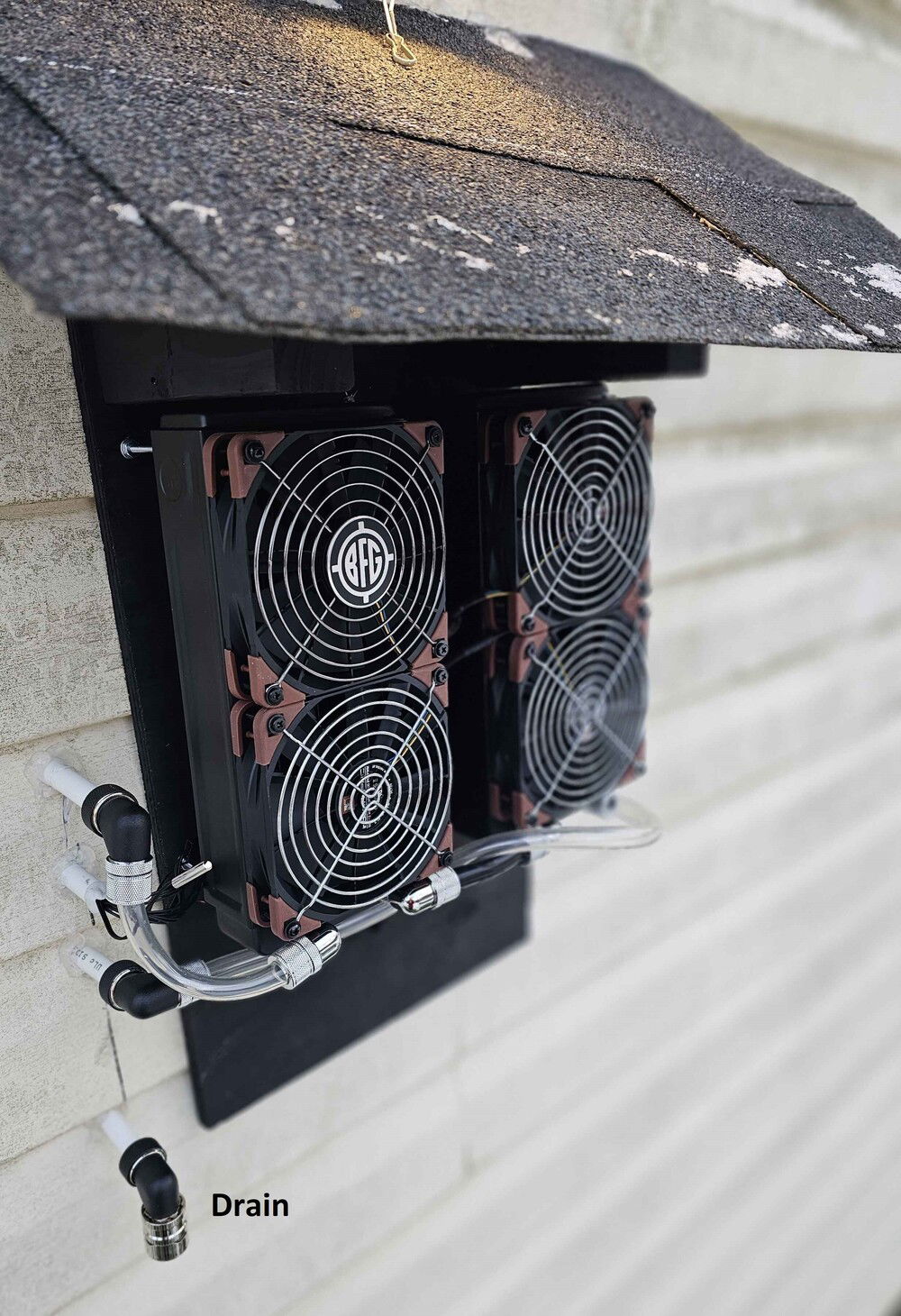 Outdoor radiators mounted.  I had to snag some scrap fan grills.  the BFG one came from a dead powersupply.  Note the drain pipe.