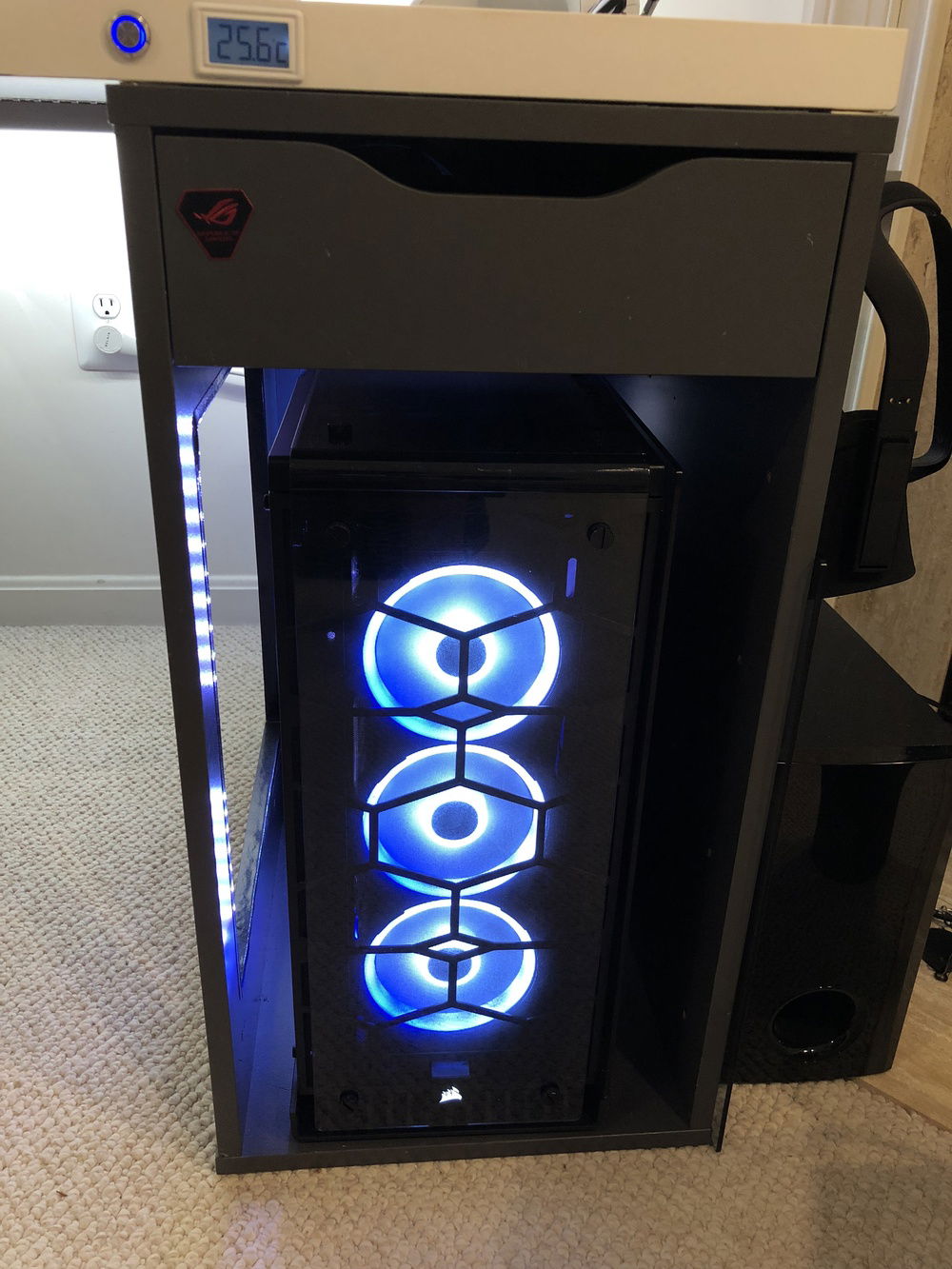 Custom button drilled into the desk turns on the computer and powers on the monitors. The display indicates water temperature.