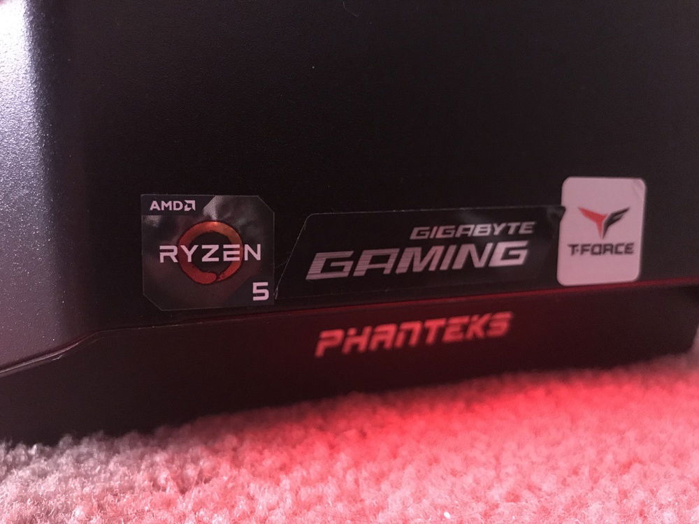 The front panel with the stickers as followed: ryzen 5 sticker, gigabyte gaming sticker (from the motherboard) and a Team Group sticker from the ram, as well as the case light