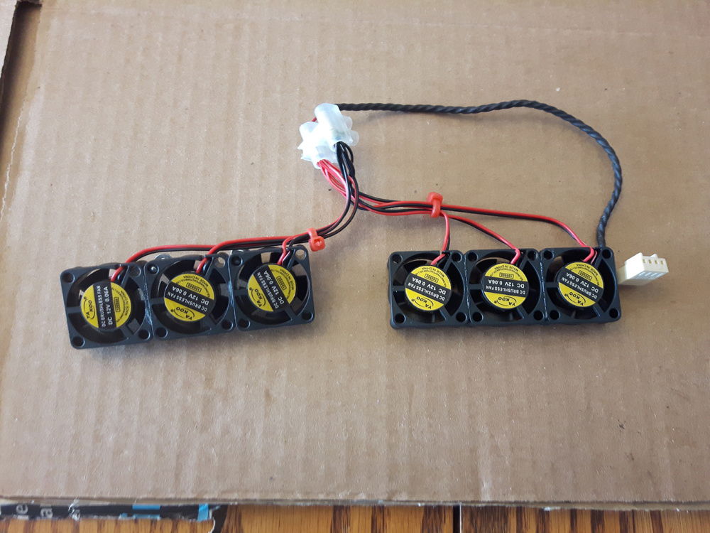 20mm fans super-glued together into banks of 3. i put them on the motherboard to measure out the wires before cutting them. The connector is from an old fan.