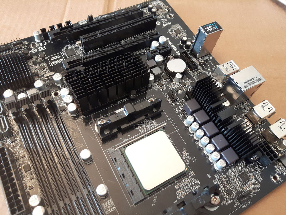 Motherboard heat sinks without fans. You can see some scuffs from screwing the fans to them to measure the wires.