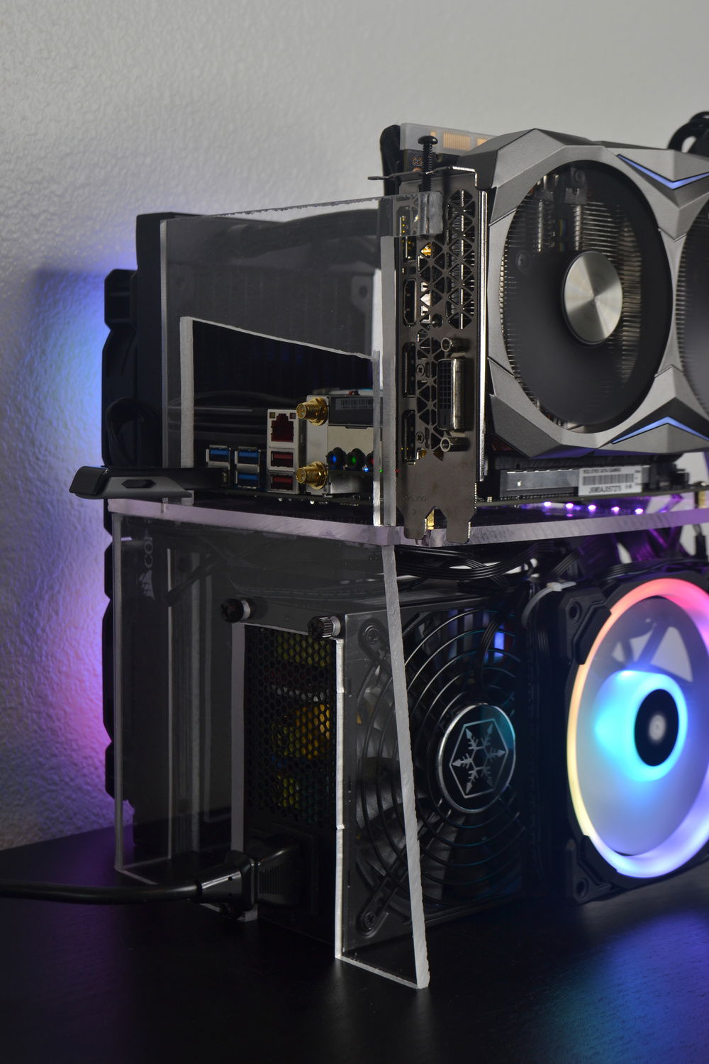 The piece on the top is to hold the graphics card down. The acrylic cement is surprisingly strong, even holding down a piece with such little surface area to bond.