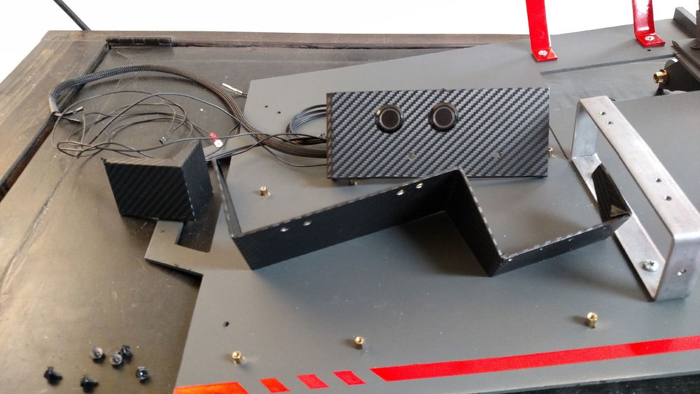 A little faux carbon wrap around the bent aluminum housings.  Ready to hide the IO panel behind a nice clean look.