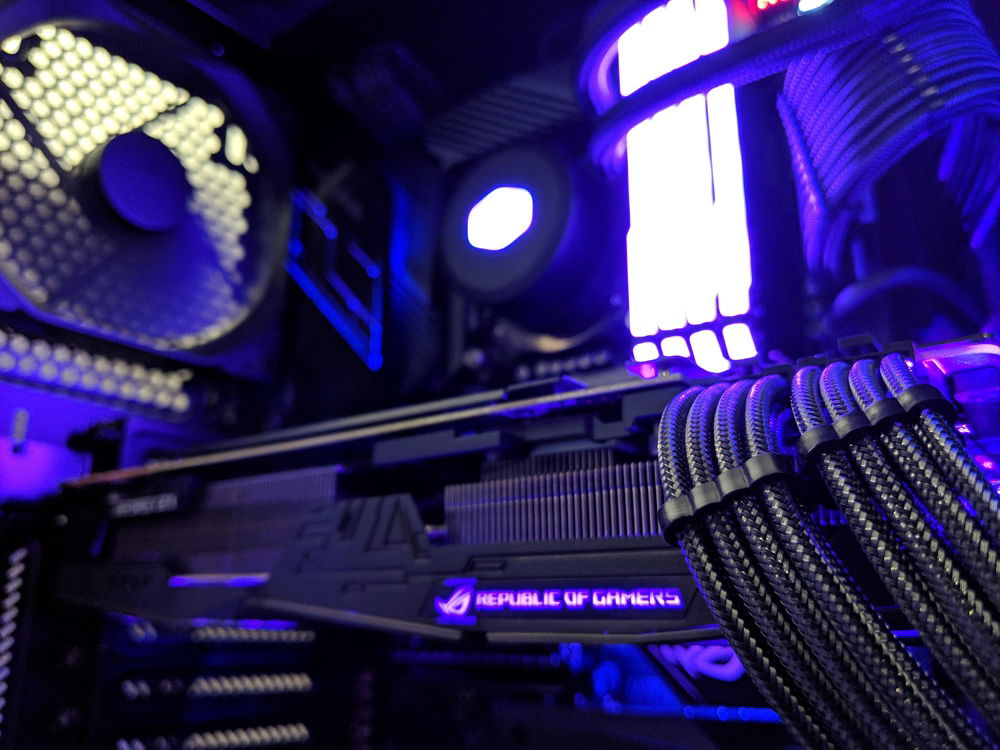 GPU focused shot accentuating the RGB lighting of the strix card and the carbon cables.