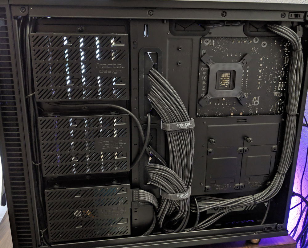 Back side of the case. Removed the fan hub that comes premounted on the case since I already have a lot of fan headers on the motherboard. It also makes for a pretty clean backside. I ended up bying a 2nd TG panel for this side. Next picture shows the first cable management run I did when building this.