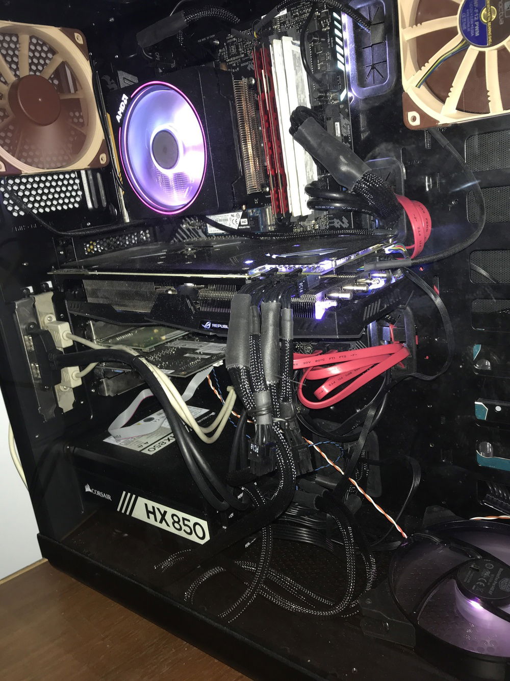 An AMD Wraith PRISM cools the Ryzen 7 2700X CPU. The RGB on the PRISM is controlled by the motherboards sole RGB header. The GPU is an Asus Strix Vega64. Four sticks of Crucial Ballistic Sport LT 2666 8GB (salvaged from the failed Red Dead Ravager project) gives this machine a whopping 32GB of RAM. The DWA-582 was a pointless add, I was hoping to use the build to also work as a Airplay or Chrome cast receiver so I can stream games from my iPad or cellphone (it doesn't support doing that). The Blackmagic Intensity Pro combined with a Lightning HDMI adapter makes up for what the WiFi adapter can't do. And lastly, the X-Fi as a signature of all my builds.

The two NF-F12s were salvaged from the failed "Red Dead Ravager" project. One is hooked up to the motherboard directly. The other to the GPU. The sole MasterFan Air Flow 140 RGB on the base is solely controlled by the GPU.