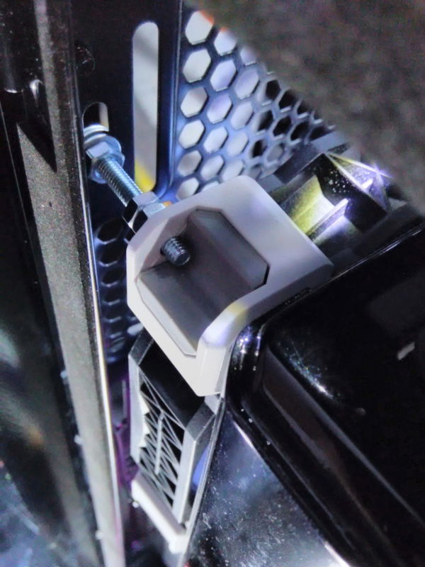 Because this 60mm thick 140mm radiator wouldn't natively fit on the rear exhaust mount without interfering with the motherboard, I had to offset it from the chassis with these improvised standoffs on every other corner that you see here. I couldn't fit a nut on the end of the bolt to secure it, so the way it's actually secured is shown in the next picture.