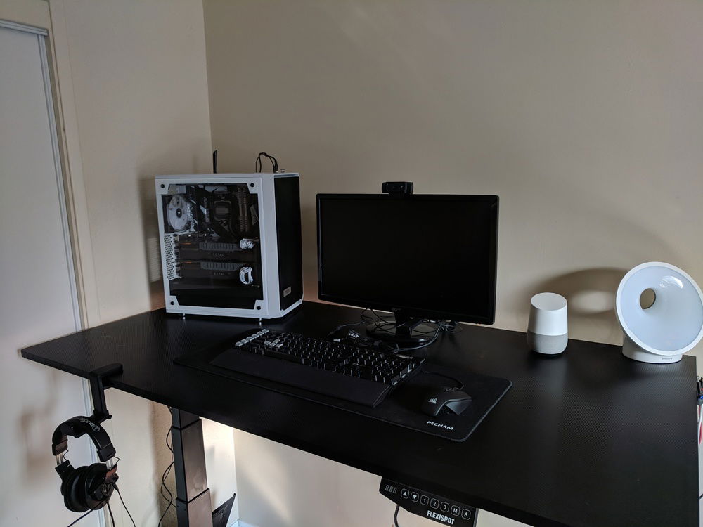 This was my set up before I got my new BenQ Monitor. Custom sit-stand desk with a carbon vinal wrapped top surface. Weird O- thing to the left is actually my Philips sunrise alarm clock, I have to wake up super early, so between that, and my Philips Hue lights kicking on in the morning I can normally get up far before the sun rises.