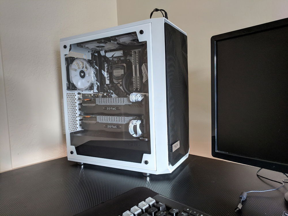 Outside of the case looks relatively normal, however, I actually had to cut out the entire inside of the front panel. That allowed me to sandwich the 280mm RAD and dual 140mm RGB Fans into this case. Just barely allowing enough room for the giant three slot Zotac AMP! Extreme Edition 980TIs to fit... with almost no room to breath. So I to somewhat hold them apart with a custom cut GPU stand that pushed one card up and pulled the other down. Using black zip ties to further reduce strain on the motherboard. To me, it came out looking pretty clean, all things considered. The case was really not meant for this much hardware.