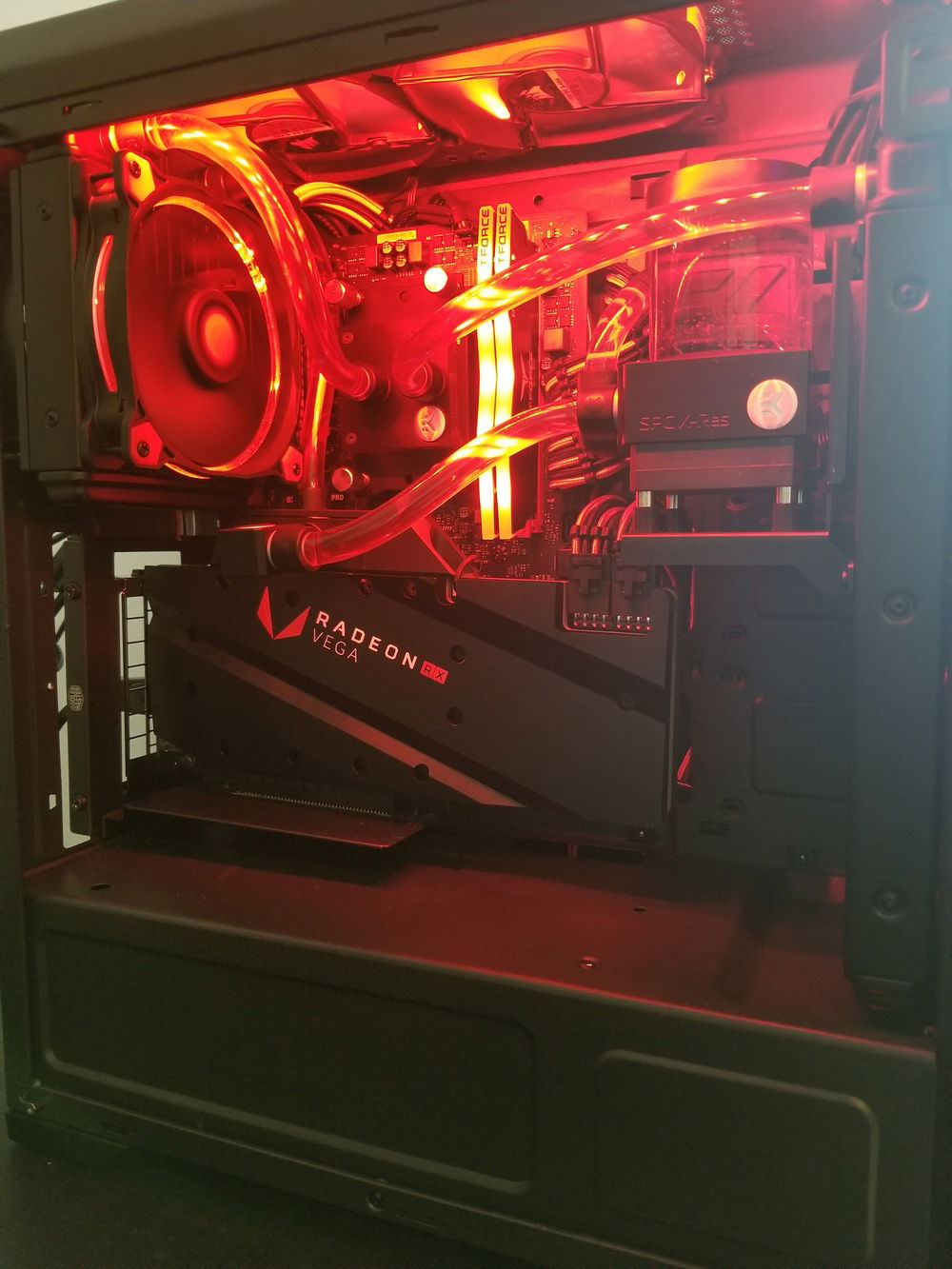 Current loop, glass panel removed. I've since removed the 120mm fans on the top after doing some testing and figuring out they have literally 0 effect on temps. They were also noisy as all hell because they were right up against the top filter.
