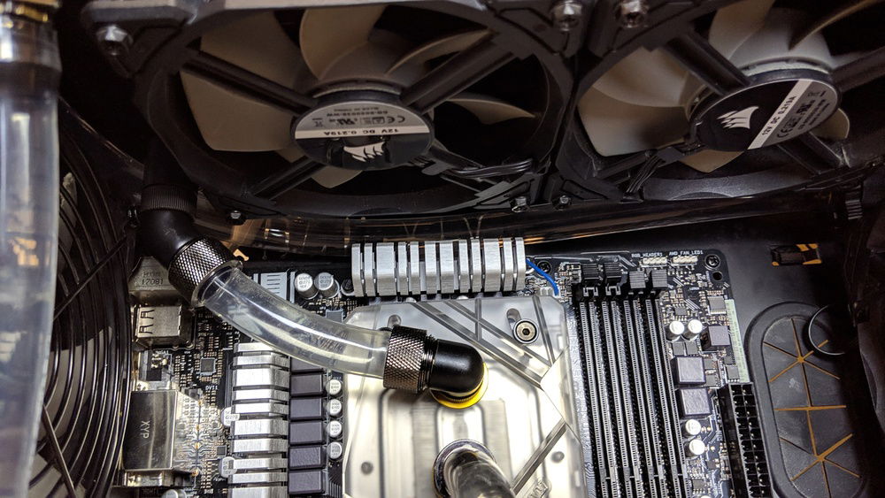 The return line from the front radiator is tucked up above the motherboard.