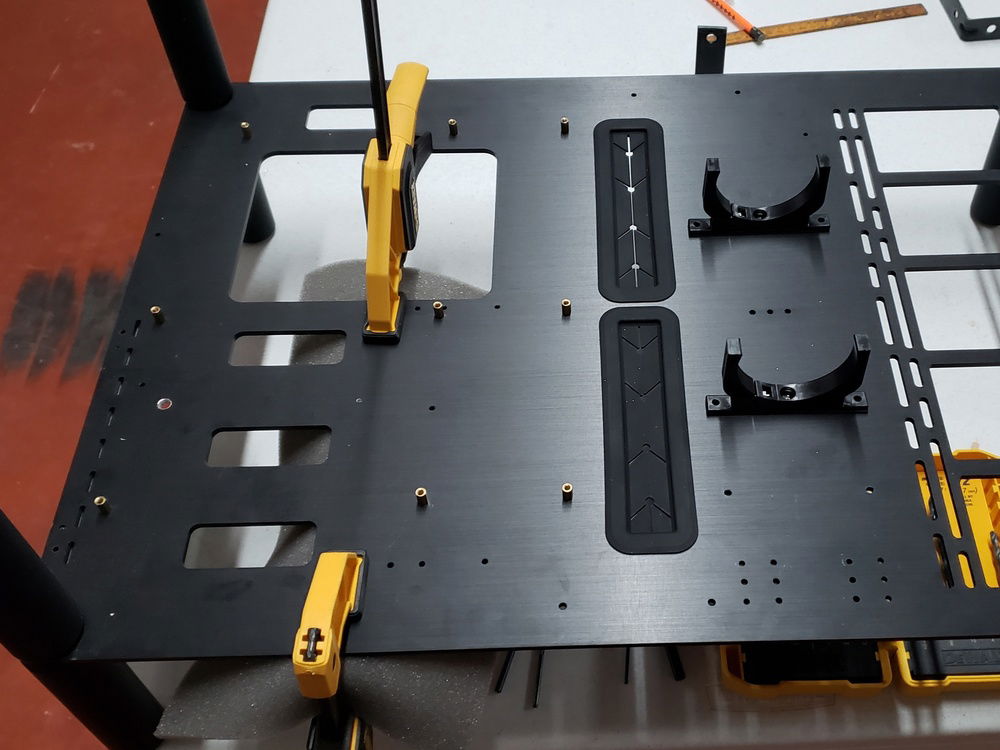 We realized quickly that the EVGA 1080Ti FTW3 w/ EK Waterblock was going to be heavier than the vertical GPU mount could handle safely (in our expert opinion). Drilling holes to fasten the newly fabricated vertical GPU support brackets to the case.