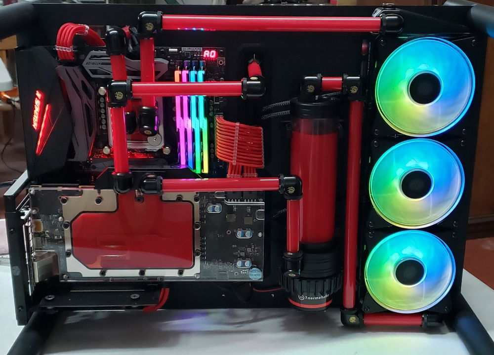 COMPLETE! For real this time! You can see instead of running the tubing from GPU to CPU we routed the tubing from the GPU exit to the second radiator in the back and then from that 2nd back rad to the CPU. We were able to drastically reduce the temps from the original layout we had created. Again, this case was NOT created to run double rads, so a lot of modding and fabricating took place.