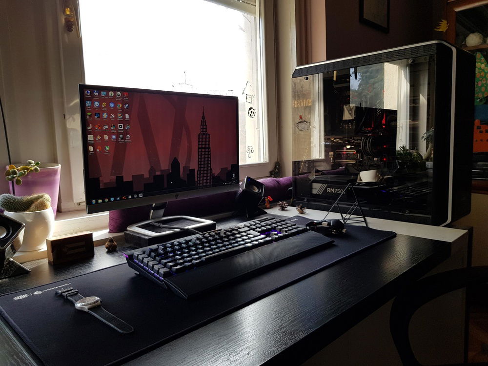 Picture of the entire setup, including the keyboard, mouse, monitor and a weird pyramid thing from IKEA.