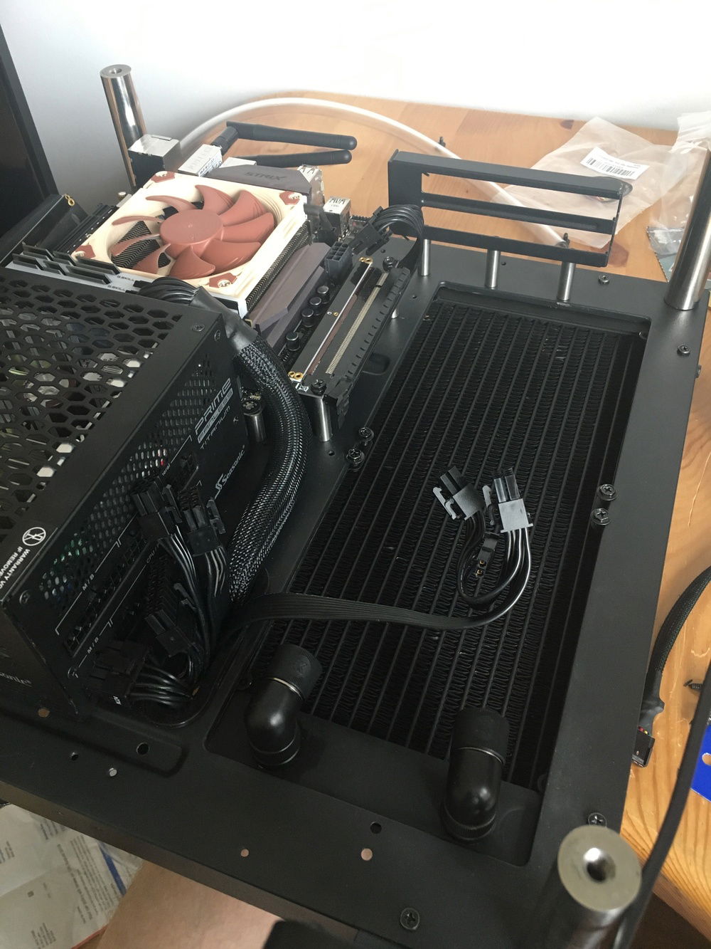 Skip several months and a few purchases. Fanless PSU and 280mm radiator. Entire liquid cooling loop to go in. To give the radiator more room to breath I had little stainless steel standoffs name to move the bracket away from the case. Did the same for the riser cable and the motherboard (just because).