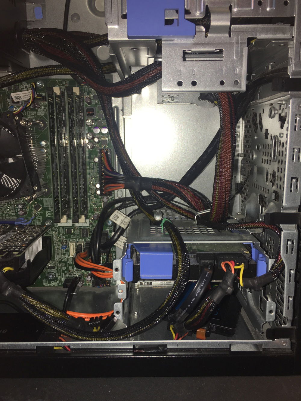 UPDATE: There's a LOT going on here, but I did what I could. I finally realized that I could put the SATA cords through the drive cage to reduce clutter a soon as possible, and had the PCIE 6-pin routed a little cleaner as well