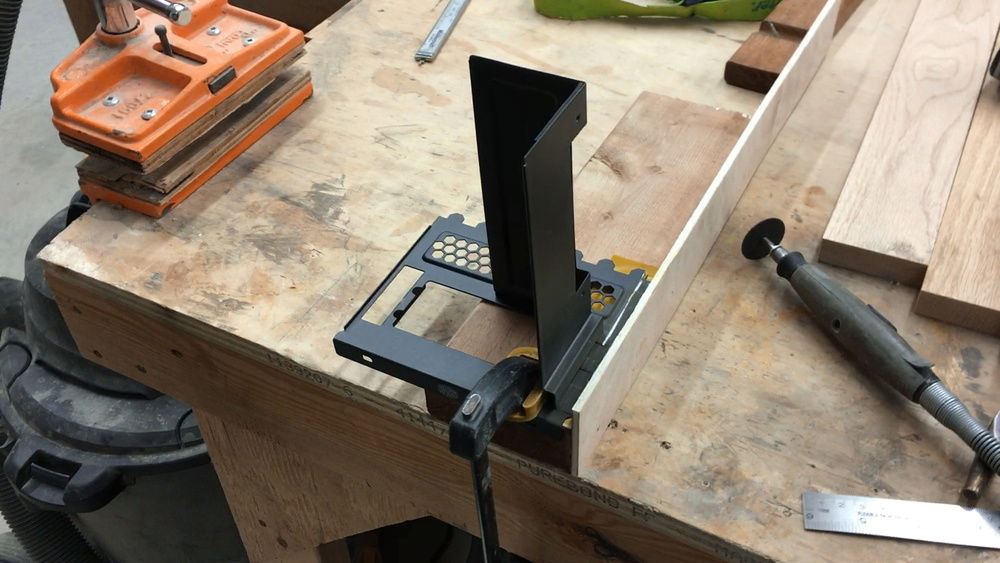 Modding the vertical GPU mount to make it smaller so it doesn't take up all the PCIe slots.  The before shot.