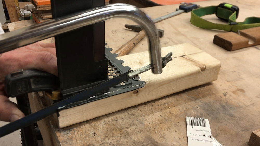 Modding the vertical GPU mount to make it smaller so it doesn't take up all the PCIe slots.  Hacksaw worked best to remove the bottom bit.