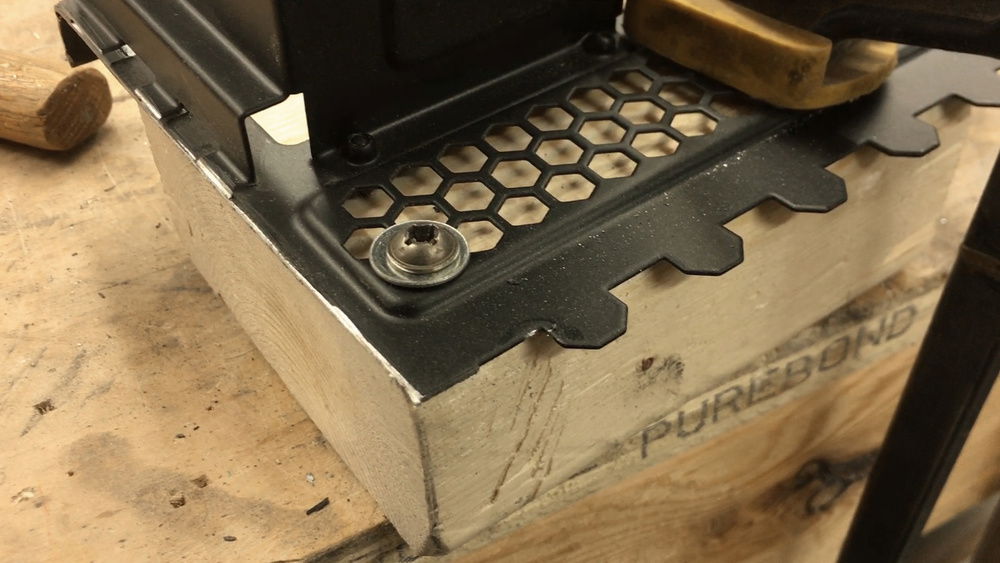 Modding the vertical GPU mount to make it smaller so it doesn't take up all the PCIe slots.  Finished cuts.