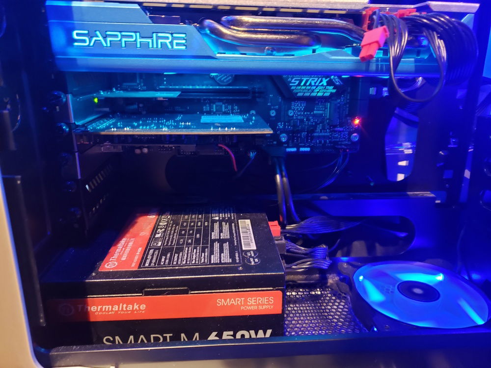 Below the graphics card showing the 120mm fan, power supply, ethernet port, and sound card.