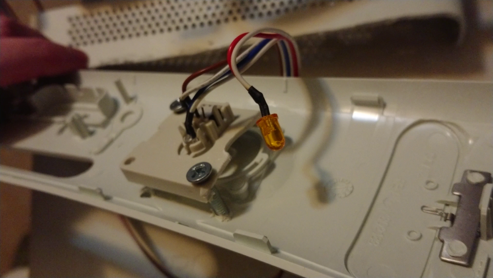 This is an old PC button with hard drive light I had laying around. I just drilled holes in the face and attached it with some loose screws, works great!