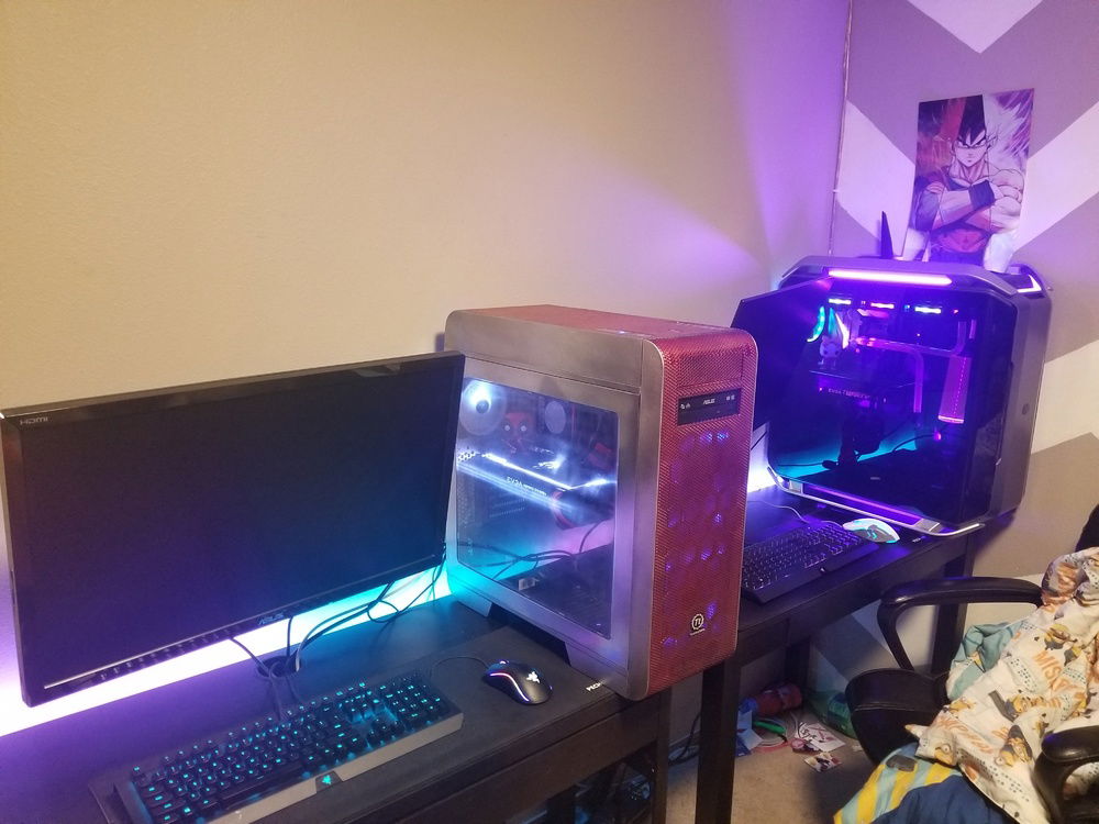 his and hers gaming desktops both running with desktop lights on.